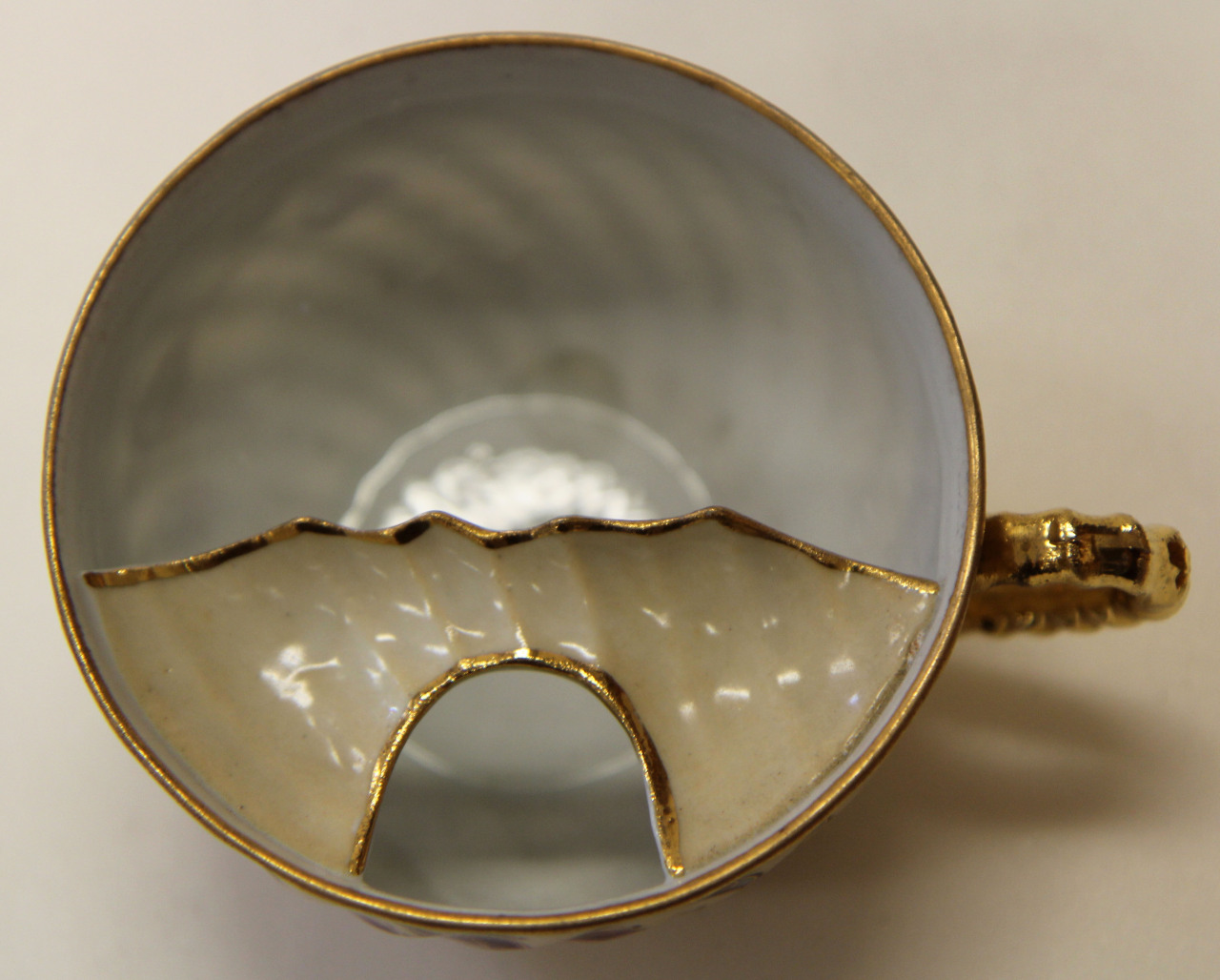 flemingmuseumofart:  Teacup with mustache guard. Glazed porcelain, gold. c. 1885.