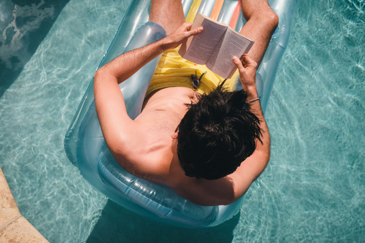 A book and a pool, Aruba, 2019. #man#book#reading#pool#summer#sun#water#fuji#fujifilm#fujixseries#fujix100t#x100t