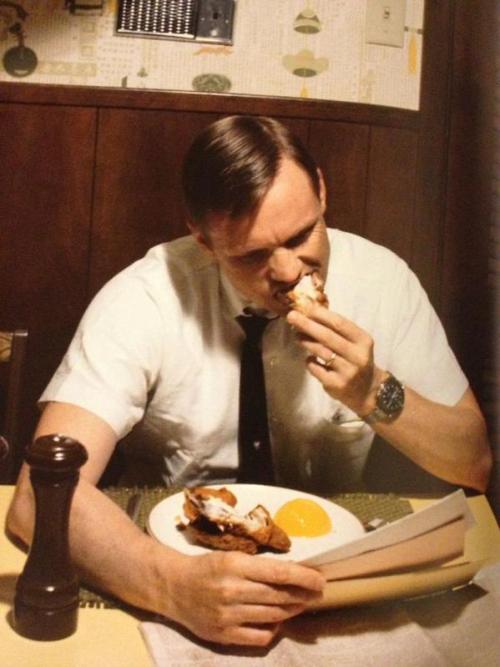 Neil Armstrong eating his last breakfast on Earth before leaving for the moon.