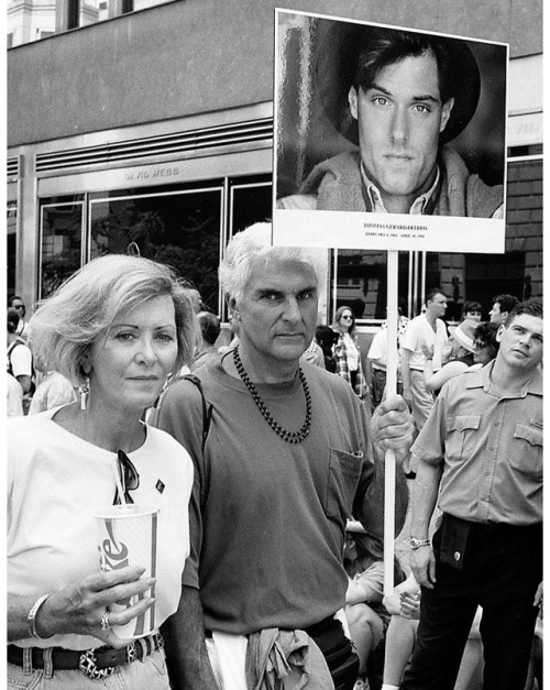 “THOMAS GERARD DELDEO, FEBRUARY 4, 1963 – APRIL 18, 1994,” Barbara and Sal Deldeo carry a picture of