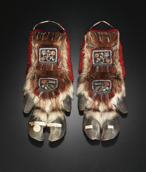 Pair of moosehair embroidered caribou leg pouches each mounted on cloth with red stroud trim, the fr