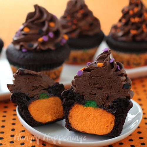 confectionerybliss:  The Ultimate Chocolate Cupcakes Stuffed with Cheesecake Pumpkins // Hungry Happenings 