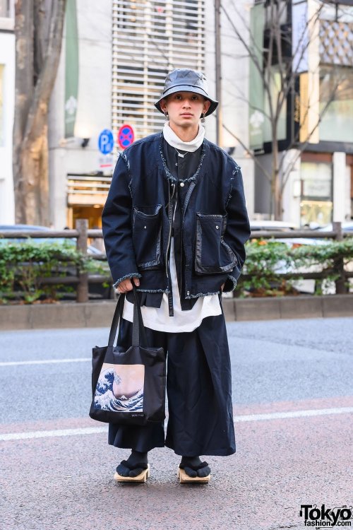 Japanese apparel worker Takamitsu on the street in Harajuku wearing a jacket and top from Not Conven