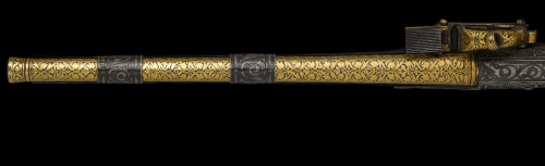 A gold and silver decorated miquelet pistol, leather wrapped and with an ivory butt, originates from
