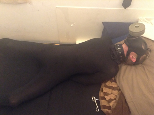 pupdonnie:  In a morphsuit with legs spread wide and hands securely shackled, pupdonnie’s eyes grow wide in horny anticipation from behind the restrictive gas mask. 