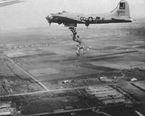  “B-17G Fortress “Liquid-8-Or” of 569th Bomb Squadron dropping cases of “10 in 1” rations into