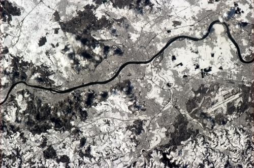 colchrishadfield:  Bonn, capital of pre-unification West Germany, neatly clear in the March snow along the dark waters of the Rhine.  