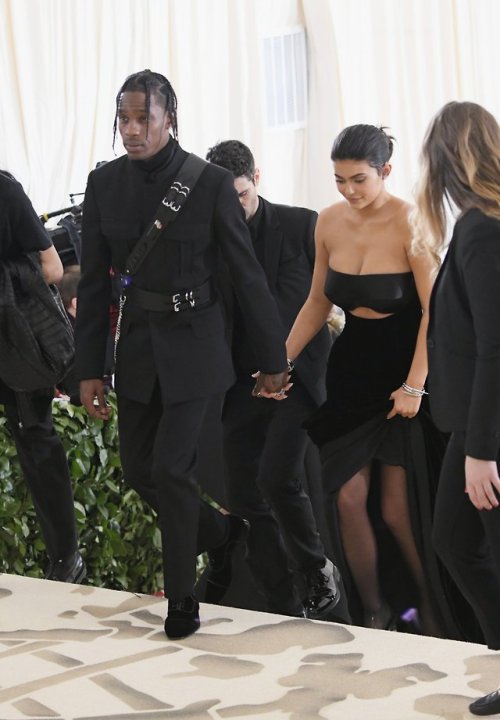 Travis Scott in custom Alexander Wang military tuxedo with leather harness & Kylie Jenner in cus