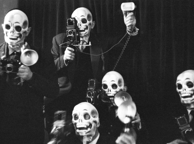 Actress Béatrice Altariba with photographers wearing skull masks at the premiere of the film 