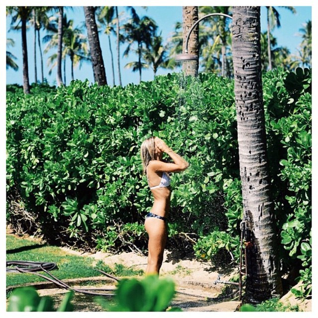 Ellie enjoying an outdoor shower in #Hawaii wearing our midnight tropic cheeky bottoms