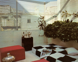 80sdeco:  checkboard patio bed, red ottoman, black lacquered bar cart, white slatted screening supremeinteriors MODERN FURNITURE AND DECORATION | Robert Harling ©1971 