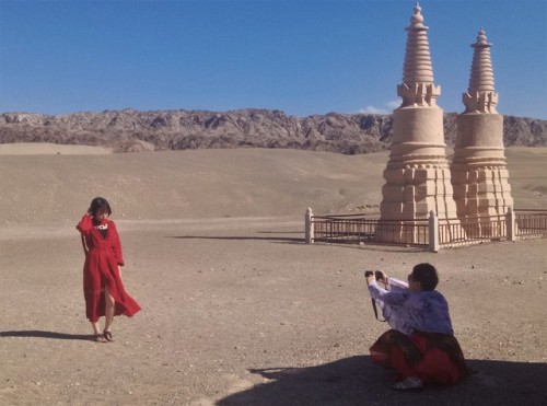 Chinese tourists taking pictures near Dunhuang, Gansu