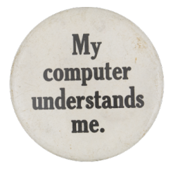 a white pin with black text that reads 'My computer understands me.'