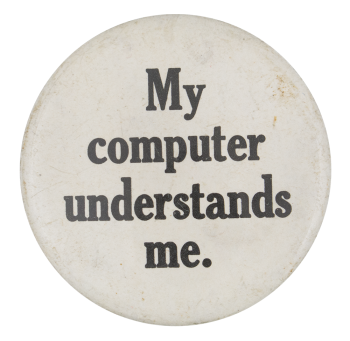 a white pin with black text reading 'My computer understands me.'