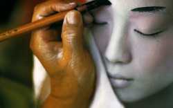 coltre:  A geisha getting her makeup done. 