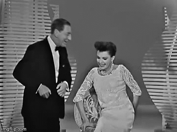 audreyheckburn:  Ray Bolger giving Judy Garland a few clues on what he’d like her to sing(and making her look adorable) on the Judy Garland Show, #10(x) 