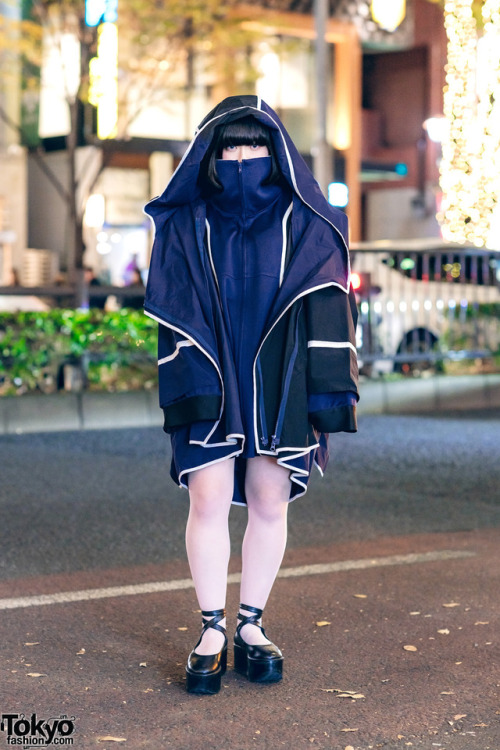 16-year-old Japanese student Kana on the street in Harajuku wearing a hooded coat by the futuristic 