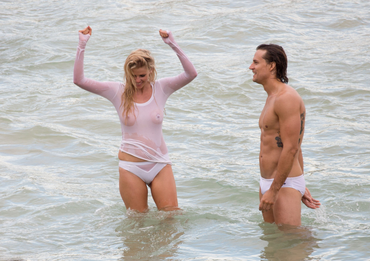 toplessbeachcelebs:  Lara Stone (Dutch Model) in a wet see-through top during a photoshoot