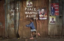 unrar:  A young girl runs past pro-peace graffiti written during the post-election violence of the previous election in 2007 and a poster of presidential candidate Raila Odinga, center-right, in the Kibera slum of Nairobi, Kenya. . Ben Curtis    