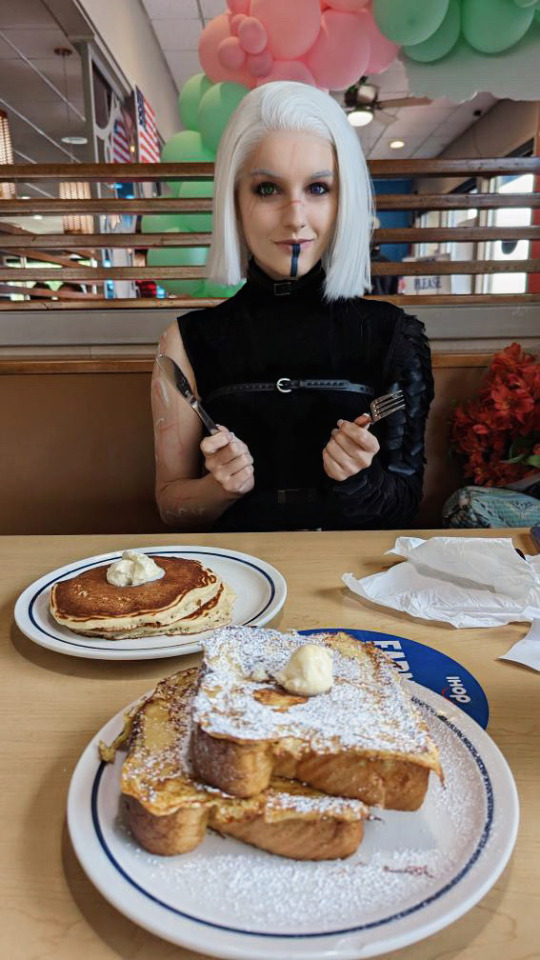 Arm wrestling for the bill in goth girl IHOP.