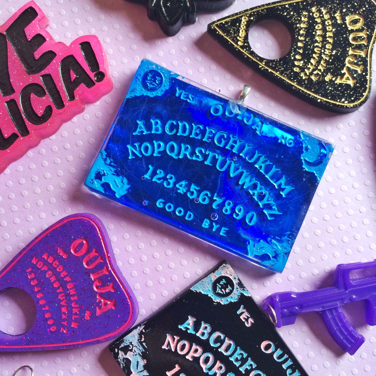 jinxandcurses:  NEW! Holographic ouija boards in planchettes in pink, purple, blue,