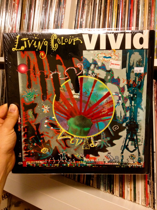 vinylanswer:  Vivid remains a truly great album, but it has one of the ugliest covers of all-time. What makes this particular copy even worse, however, is that vintage Tower Records sticker, selling it brand-new for ů.99 and the modern-day price stick,