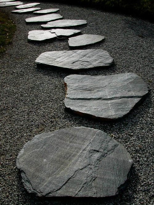 Rocks in a Japanese Zen garden represent islands, mountains, or other land mass. They symbolize calm