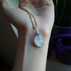 90377:  it’s all wonky and far from perfect but it’s cute for my first attempt.  wire wrapped rainbow moonstone cabochon with tanzanite aura quartz crystal bead. 