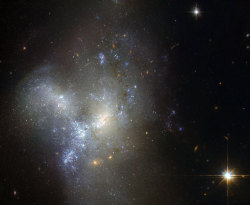 just&ndash;space:  Hubble Views Merging Galaxies in Eridanus : This image, taken by the NASA/ESA Hubble Space Telescope, shows a peculiar galaxy known as NGC 1487, lying about 30 million light-years away in the southern constellation of Eridanus.  js