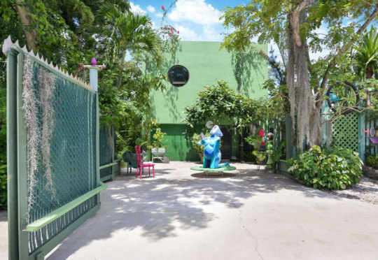 This is the super-funky Florida residence of upcycling artist Michael Jude Russo, who sold it with all art included for $1.2m. Can you imagine buying this house w/all this original art in it?It’s loaded with color adn you wouldn’t have to bring a thing.Is that green area a fireplace? I wonder if this seating is comfortable.The kitchen blends right in with the living room. The home certainly is unique.The bedroom is really special. There’s some kind of wooden reptile coming out the chair, too. Look at the big quirky but in the bathroom.The pool and gardens are beautiful, and you don’t have to mow any lawn, b/c it’s all concrete.https://inhabitat.com/own-a-funky-biophilic-home-by-an-acclaimed-upcycling-artist-for-1-2m/michael-jude-russo-house-5/ #artists house #funky modern house #unique houses#artsy house