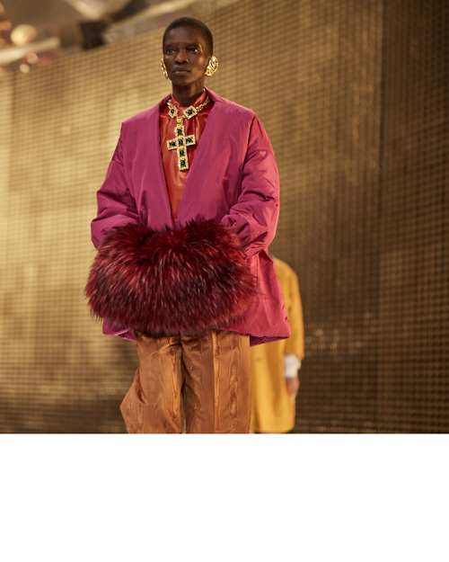 On the Gucci Fall Winter 2019 runway, colorful layering, a faux fur muff and ornate jewelry pieces i