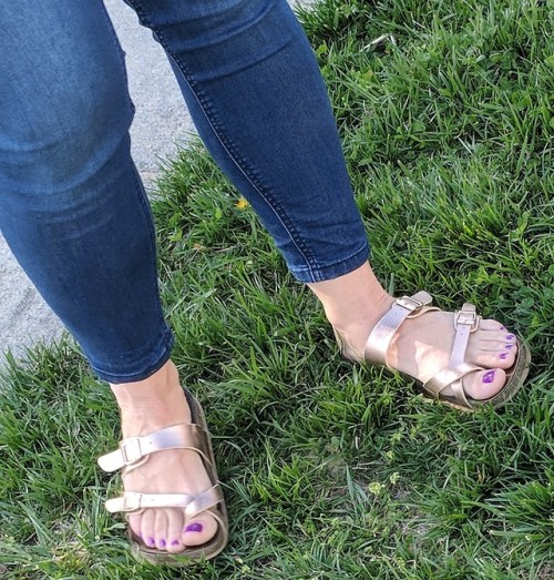 Birkenstock styled sandals on pretty feet.