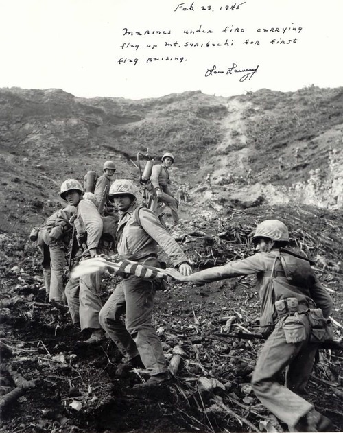greasegunburgers:  Marines carrying the first flag up Iwo Jima. 