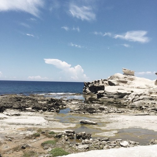 Meet me where the sky touches the sea ☁️ (at Kapurpurawan rock formation Burgos, Ilocos Norte)