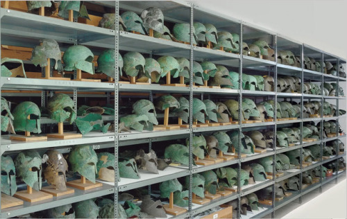 historyarchaeologyartefacts: Greek helmets, classical period, from Olympia Museum store room [1000x6