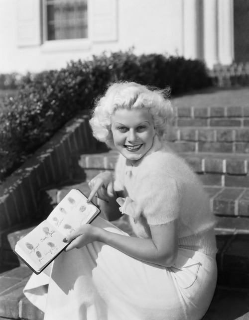 Jean Harlow with her book of autographed fingerprints including those of Joan Crawford and Clar