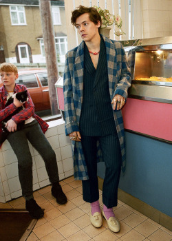 harrystylesarchive:  gucci: Inside a fish and chip shop—the set of the new #GucciTailoringcampaign—@harrystyles wears a macro gingham sharkskin dressing gown as a coat over a Heritage pinstripe wool suit. Discover more through link in bio. Creative