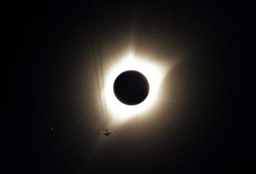 A jet plane flies by the total solar eclipse in Guernsey, Wyoming.Rick Wilking/Reuters