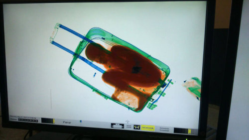 sixpenceee:  An 8-year-old boy inside a suitcase on May 8  as seen on the display of a scanner at the border crossing in Ceuta, a  Spanish enclave in North Africa. Via NYTimes