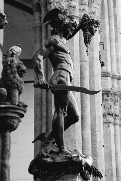 o-m-e-r-t-a:  Perseus holding the head of Medusa 