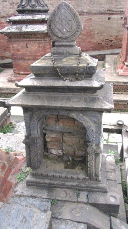 Where is the deity of this small temple in Patan Nepal? probably stolen and ending up in a museum or