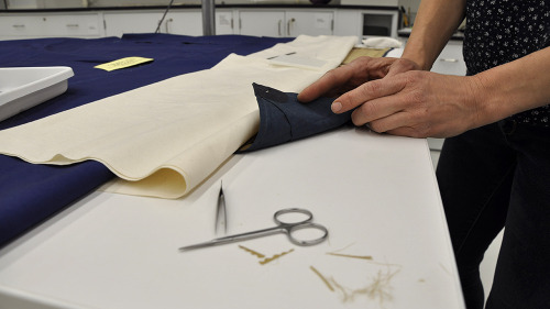 It takes a team of conservators and hours of meticulous preparation and care to get a textile ready 