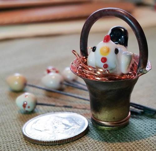 little glass chicken lisa made in a basket created from a 40 cal pistol shell.