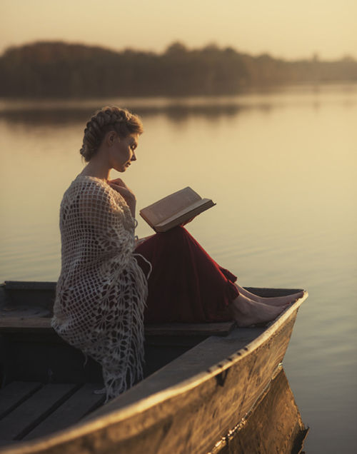 Reading on lake. Life’s simple pleasures. Photo by David Dubnitskiy.“The lake of my mind, unbroken b