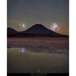 Magellanic Mountain   Image Credit &amp; Copyright: Carlos Fairbairn  Explanation: Flanked by satellite galaxies of the Milky Way a volcanic peak rises from this rugged horizon. The southern night skyscape looks toward the south over Laguna Lejia and