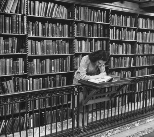  ‘Woman reading book among shelves on balcony in American History Room in New York Public Libr