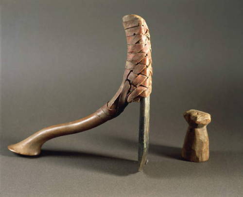 Ancient Egyptian Axe Axe with a straight cut bronze blade and a sleek wooden handle, used as a woodw