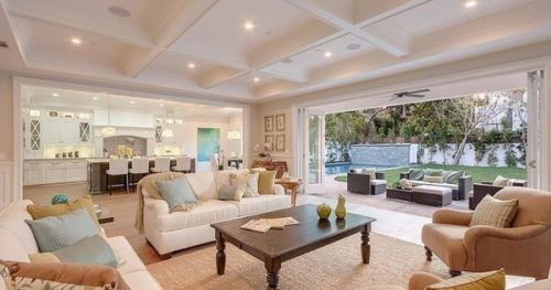 #BagoesTeakFurniture A grand room with folding doors that open up to the manicured backyard with a c