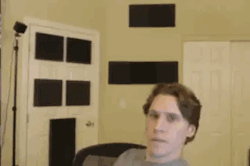 jerma in his stream set up, randomly hitting the camera with a deranged smile