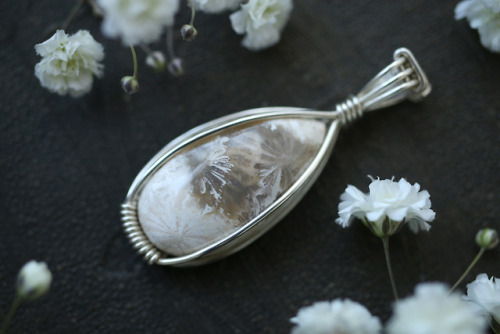 Close up of my latest sterling silver pendants - agatized fossil coral and rainbow moonstone. They&r